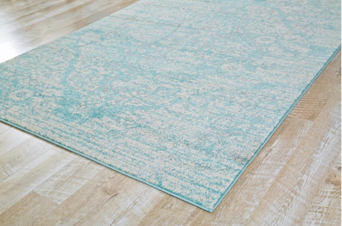 blue rug on pale wood floor