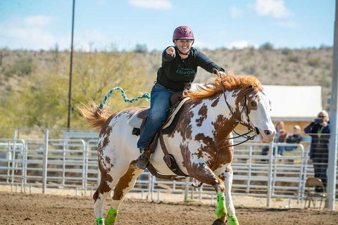 western horseback riding helmets red and white paint horse running after barrels