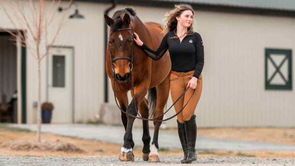 girl wearing black sun shirt walks next to bay horse, horse tack on sale, horse tack sale, breeches sale, New Years sale