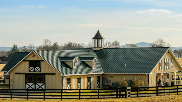 beautiful brown stable against blue sky that practices excellent fly control for horses