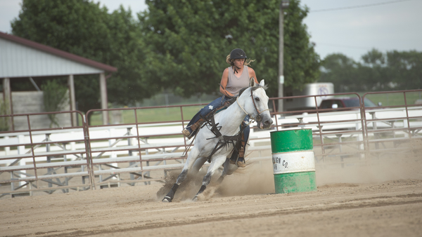 western barrel racer rounds barrel wearing best horse riding helmets