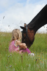 child and horse in a field, tack store