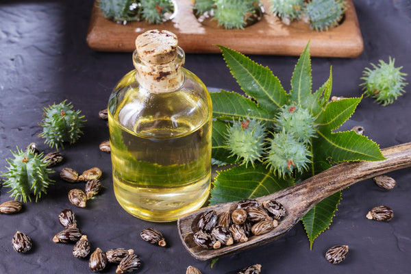 A bottle of castor oil on a black table