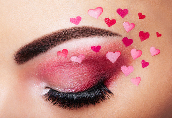 Closed eye with eyeshadow, mascara and heart makeup