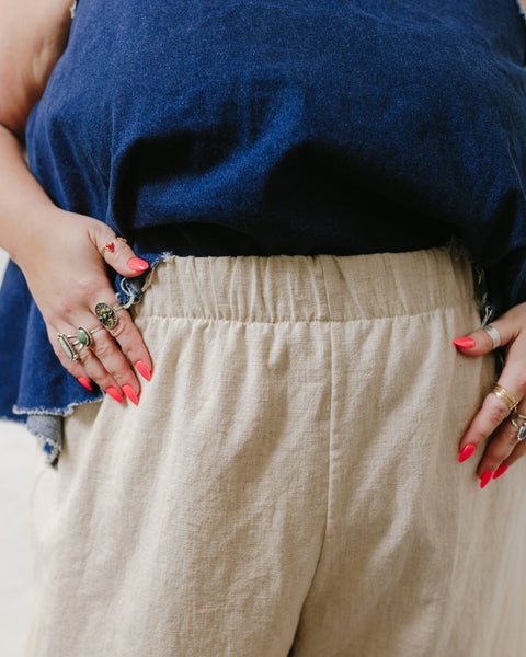 Angelina wearing oat milk linen pants with a close up of the older 2" waistband