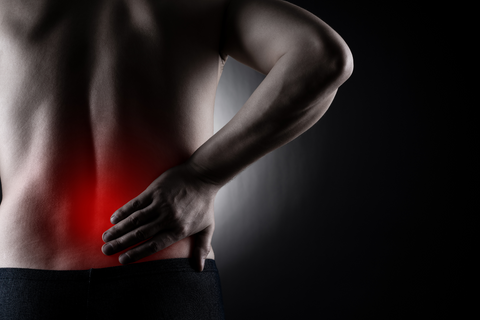 Men with hand on lower back indicating inflammation
