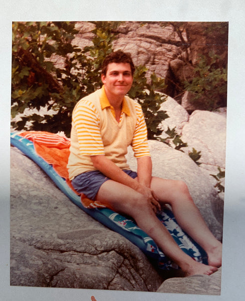 My dad in 1983 wearing a yellow polo shirt and a striped vest