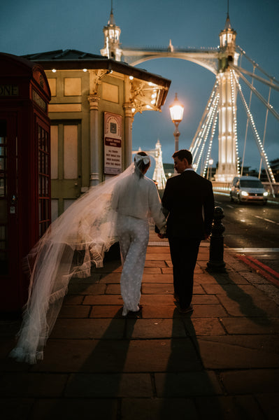 A bride and groom on Albert Bridge in London