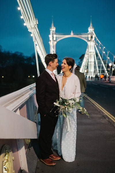 A bride and groom on Albert Bridge in London