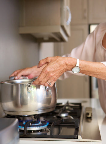 Old lady lifting a pot