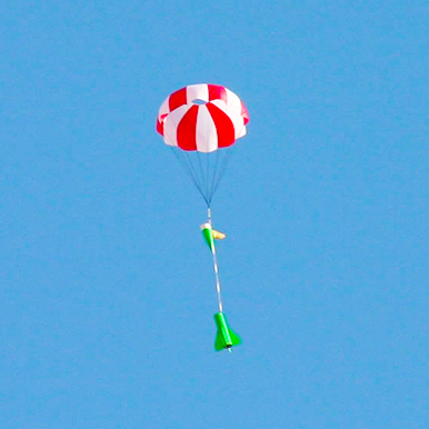 Cliff Sojourner's rocket descending under parachute.