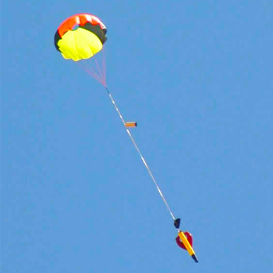 Folie a Deux rocket descending under parachute.