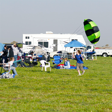 Kids playing with a Fruity Chutes parachute.