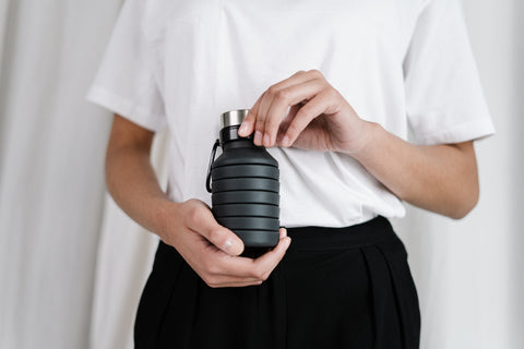 lady holding reusable water bottle 