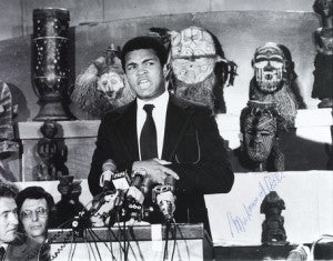 An autographed photo of Ali announcing The Rumble in the Jungle match between he and George Foreman in 1974.