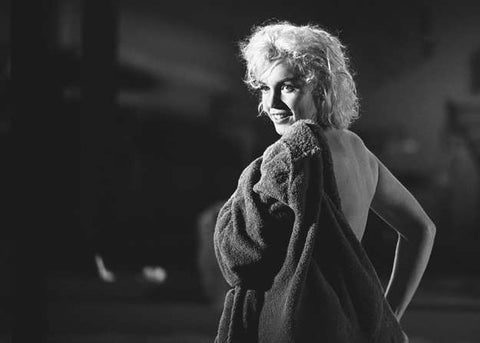 Marilyn Monroe Putting on a Robe by Lawrence Schiller. 1962. M.S. Rau.