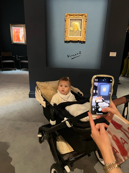 TEFAF visitor taking a picture of their child in front of Tête de paysanne à la coiffe blanche by Vincent van Gogh