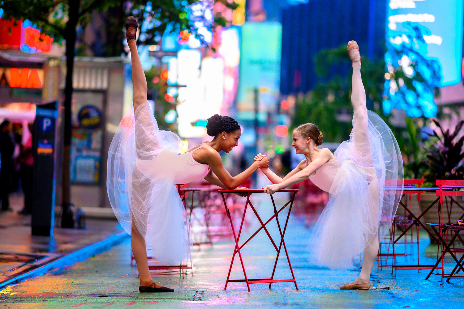 Two young dancers dancing through New York City wearing pink BLOCH leotards and tutus