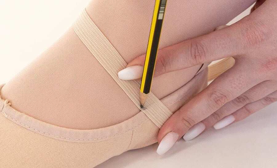 Using a pencil to mark ballet shoe elastic before sewing