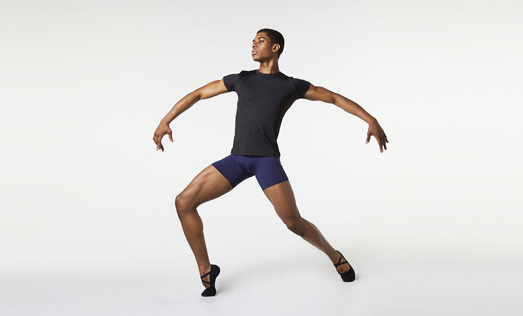 A male dancer practising his routine wearing BLOCH mens fitted t-shirt and short length rehearsal tights