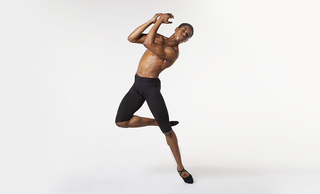 A male dancer practising his routine wearing BLOCH ballet shoes and mid length rehearsal tights
