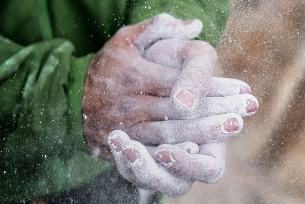 Climber's hands covered in chalk dust