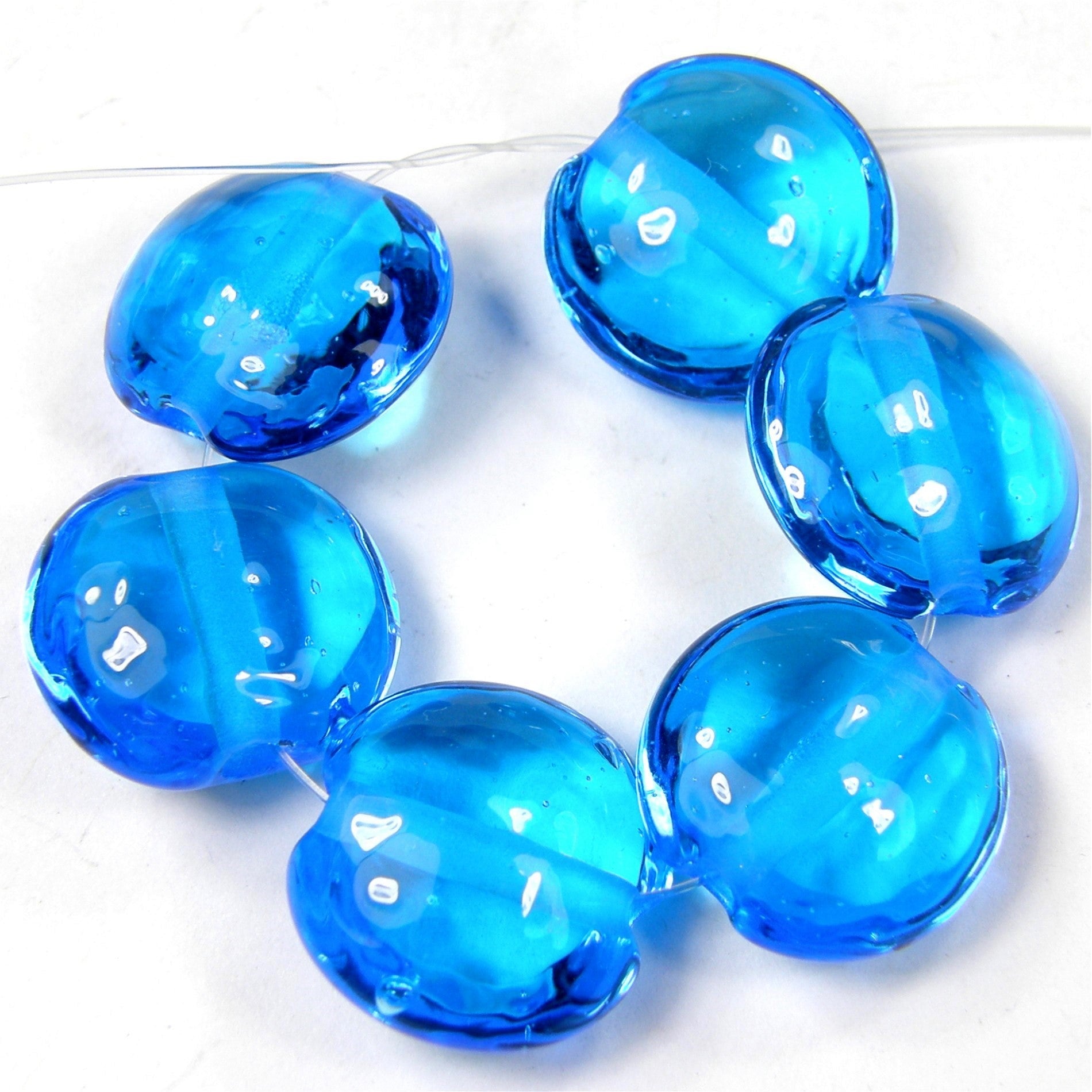 https://covergirlbeads.com/collections/new-handmade-lampwork-beads-and-artisan-handmade-jewelry/products/handmade-lampwork-glass-lentil-bead-light-aqua-blue-shiny