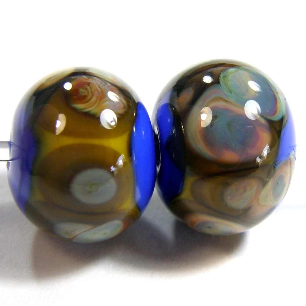 https://covergirlbeads.com/collections/handmade-lampwork-glass-band-beads/products/handmade-lampwork-glass-frit-beads-cobalt-blue-band-raku-yellow-shiny