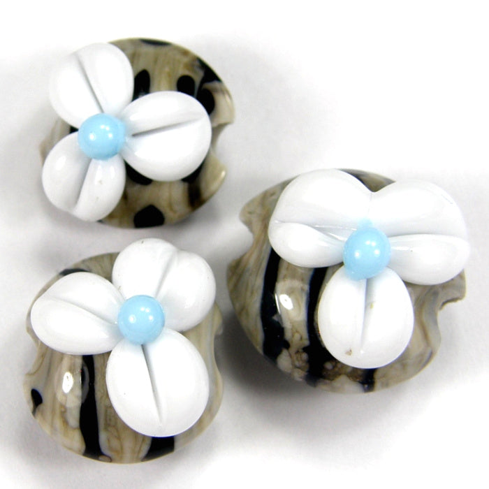 https://covergirlbeads.com/collections/handmade-lampwork-glass-flower-beads/products/handmade-lampwork-glass-lentil-bead-set-white-flowers-navy-ivory