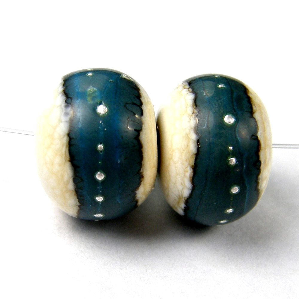 https://covergirlbeads.com/collections/handmade-lampwork-glass-band-beads/products/handmade-lampwork-glass-band-beads-ivory-turquoise-silver-shiny