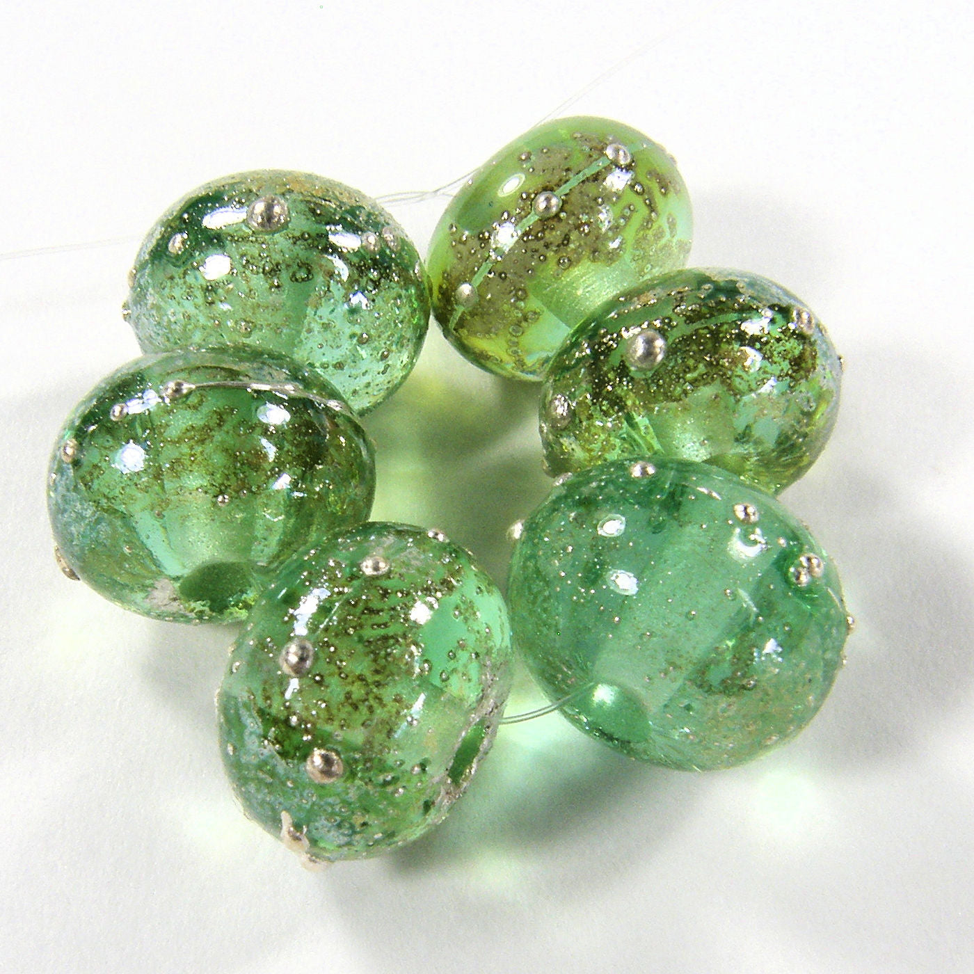 https://covergirlbeads.com/collections/new-handmade-lampwork-beads-and-artisan-handmade-jewelry/products/handmade-lampwork-glass-beads-pale-emerald-green-starlight-silver-shiny