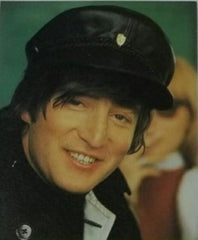 John Lennon photographed by Henry Grossman wearing his 1964 cap by Helen Anderson who has released a replica for fans everywhere
