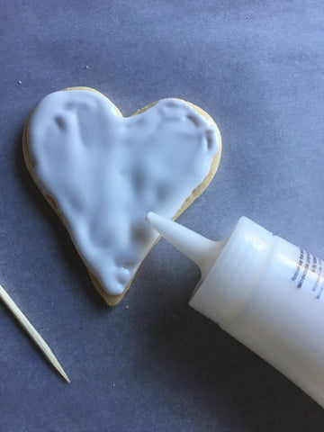 decorating heart sugar cookies with royal icing