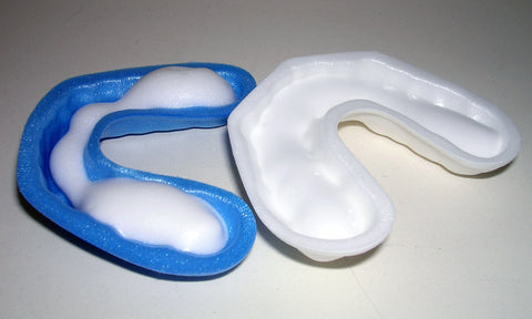 white and blue trays with fluoride