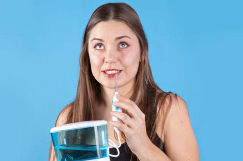 a woman using water flosser