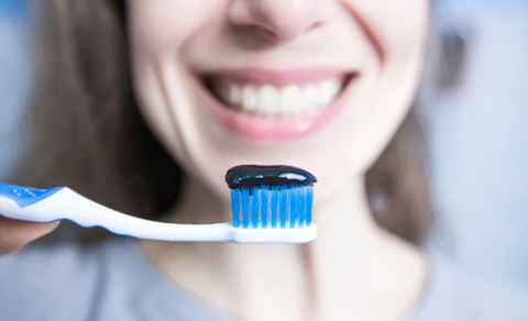 black toothpaste on the toothbrush