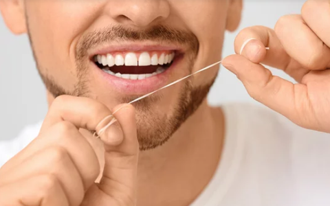 a man using dental floss