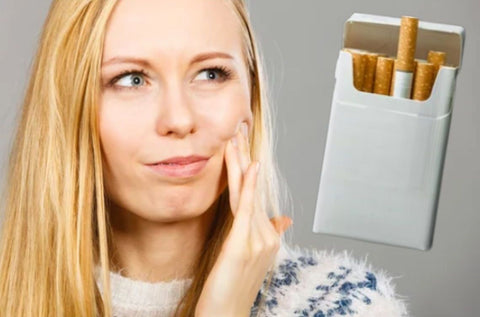 a pack of cigarettes next to a woman's face