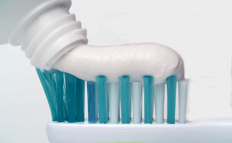 Putting toothpaste on a brush