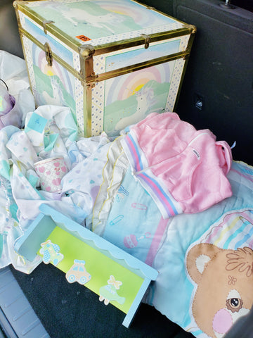 pastel colored vintage linens and unicorn trunk.