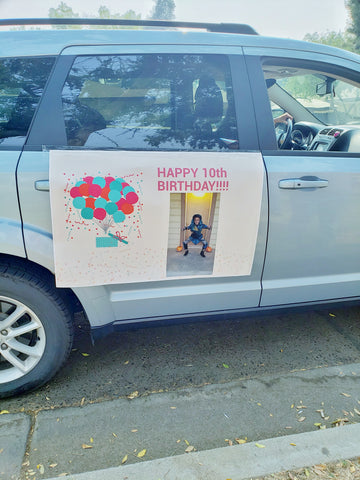 car with a "happy birthday" banner