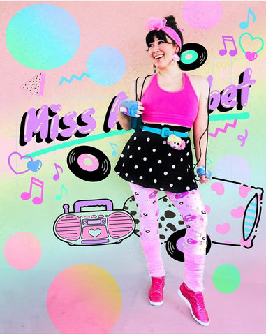 femme wearing pink boombox leggings with 80's Miss Alphabet background
