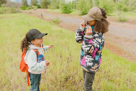 sisters exploring the outdoors in a green satin lined hat by beautifully warm