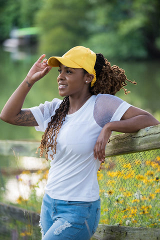 Black woman with Locs in Gold Culture Cap