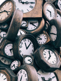 multiple wooden clocks in a pile 