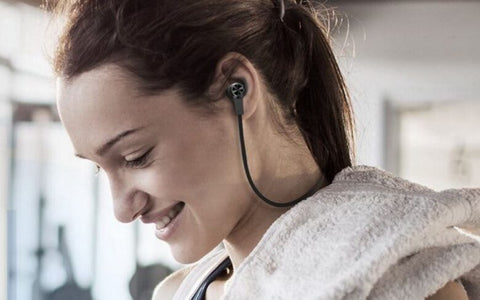 side profile of woman with black earbuds in her ears. source: cnbc.com