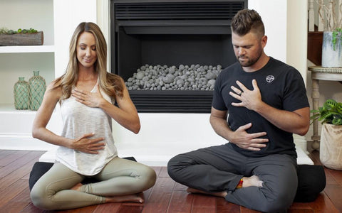 a photo of josh trent and guest meditating and performing deep breathing exercises