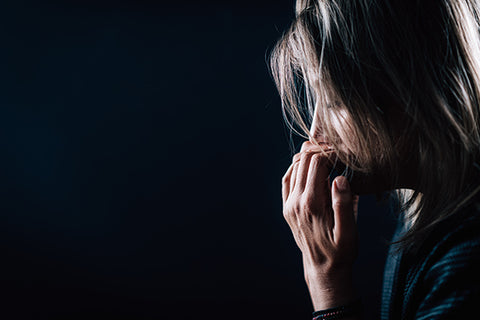 Woman bites fingernails as a visible sign of stress