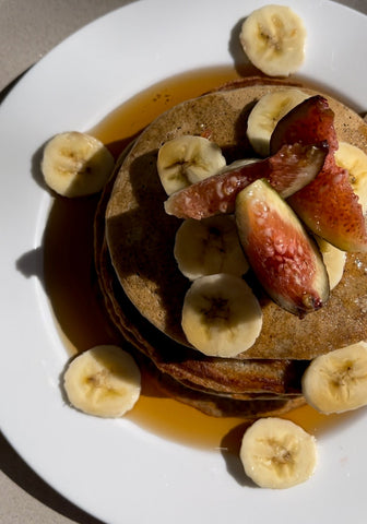 A top down shot of Lion's mane pancakes with a garnish of strawberries and bananas. 