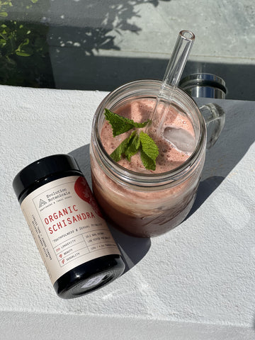 A top down shot of a jar of Organic Schisandra lying next to the finished Watermelon, mint and schisandra drink in a glass jar